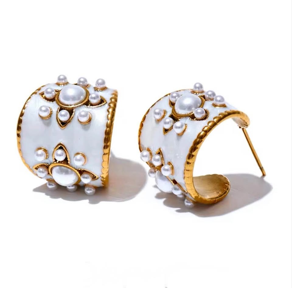 Front and back view of a pair of vintage gold vermeil hoop earrings with white enamel and pearls.