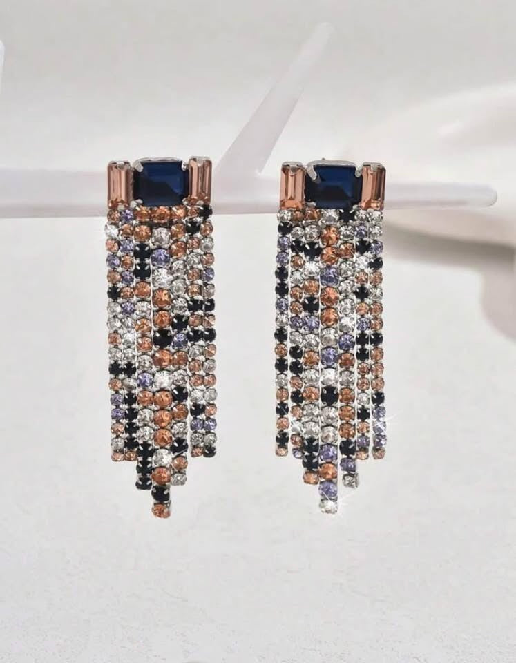  Multi-colored dangle earrings with a waterfall design. Features pink, purple, and clear gemstones.