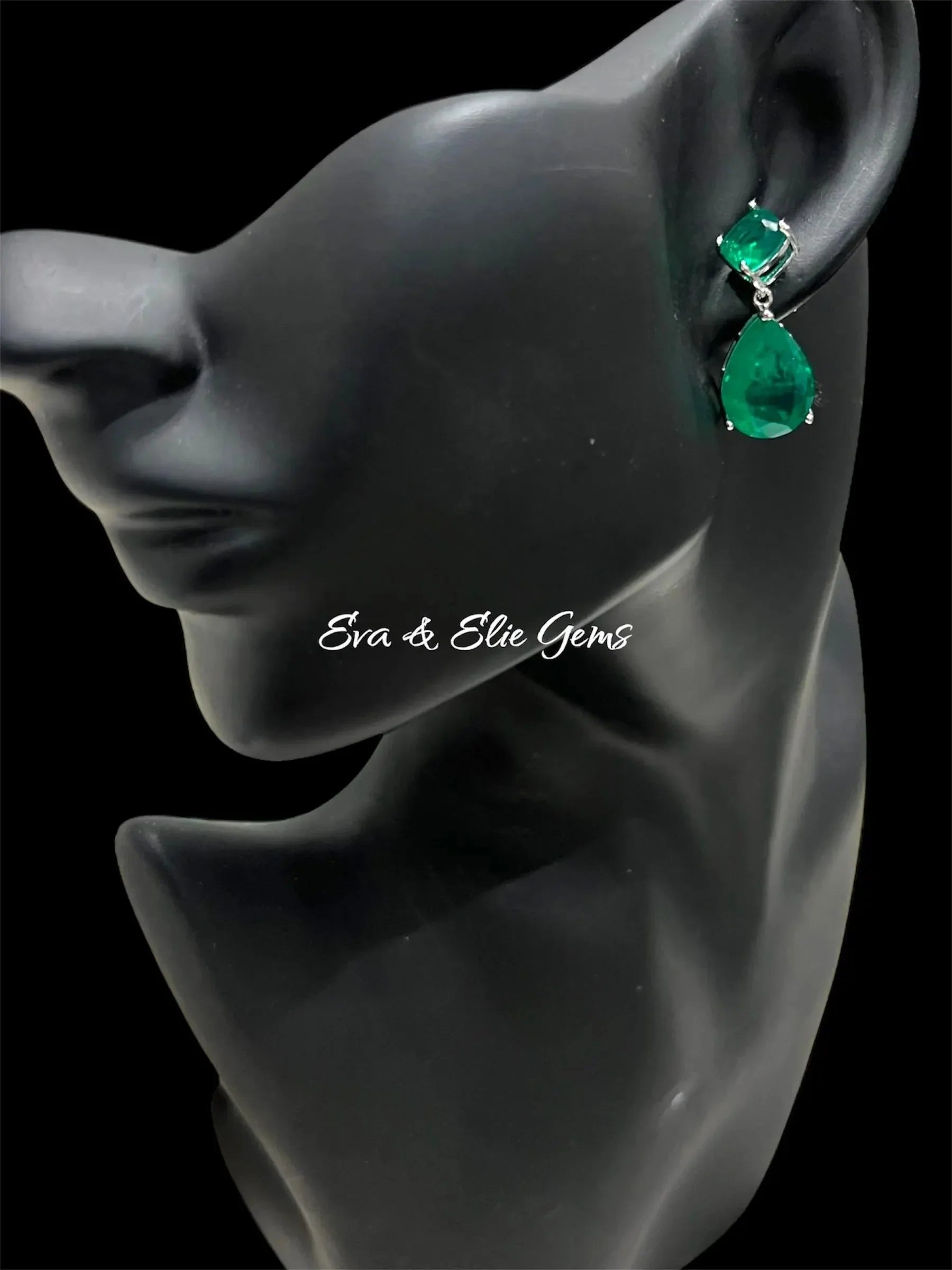Elegant Zambian emerald doublet earrings displayed on a black mannequin, showcasing their wearability.