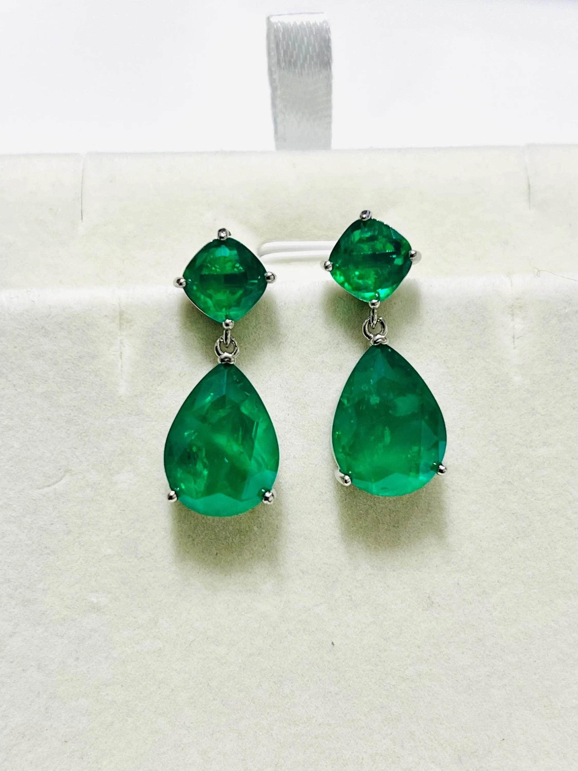 Stunning Zambian emerald doublet drop earrings in gold and rhodium, presented on a clean white background.