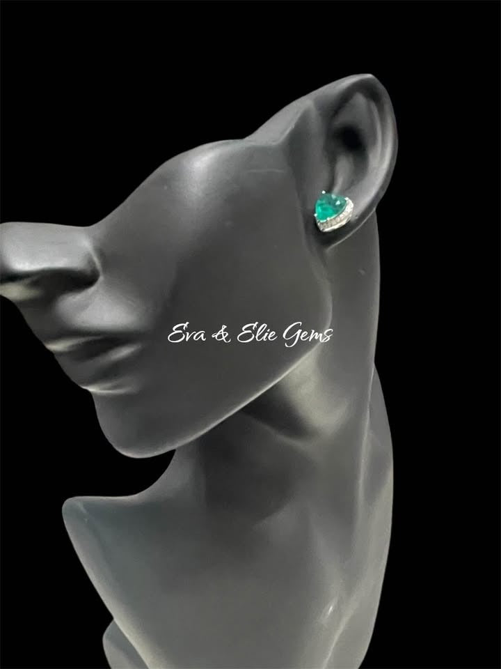 Heart-shaped Zambian emerald doublet earring with diamond halo on a black mannequin, side view.