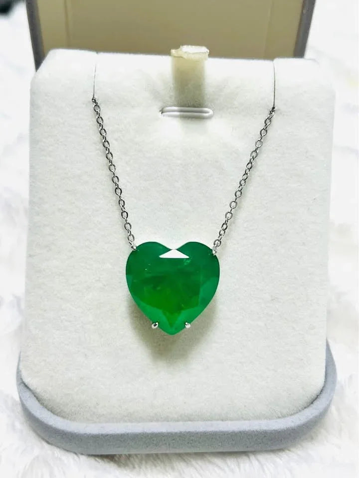Zambian emerald doublet heart necklace with a faceted gem, presented in a light grey jewelry box.