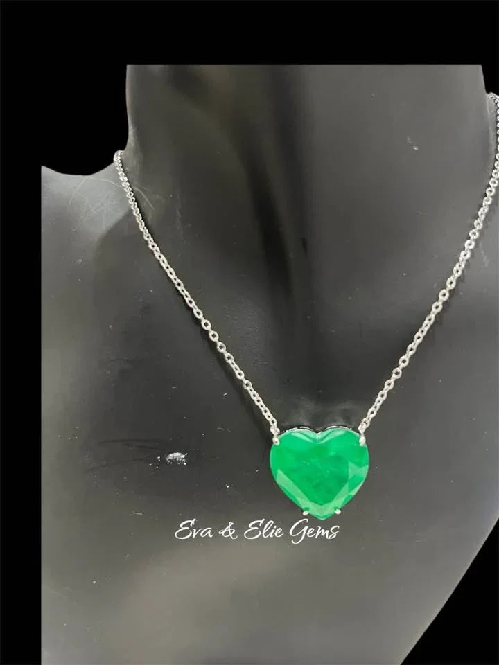 Zambian emerald doublet heart necklace on a black mannequin, showcasing the stone's vivid green.