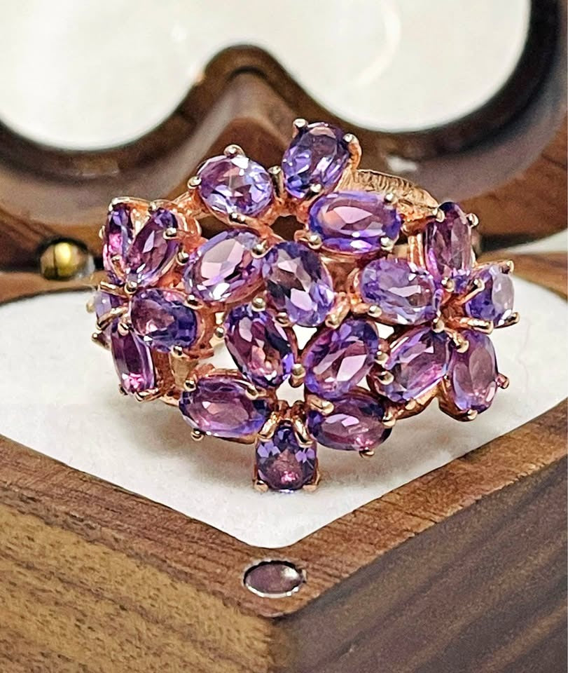 Stunning amethyst bloom cocktail ring in rose gold, displayed beautifully in a wooden ring box.