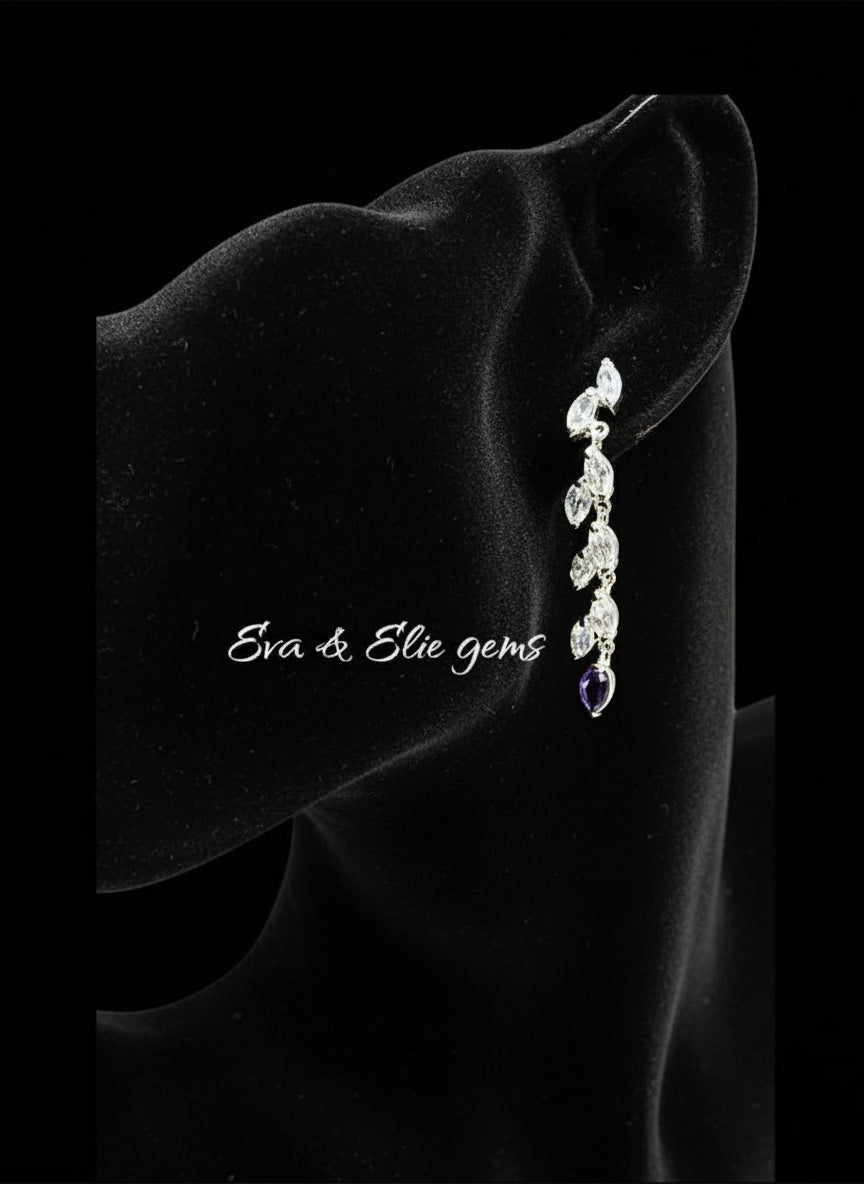 Dangle earring with natural aquamarine and amethyst, worn by a mannequin to show its elegant length and style.