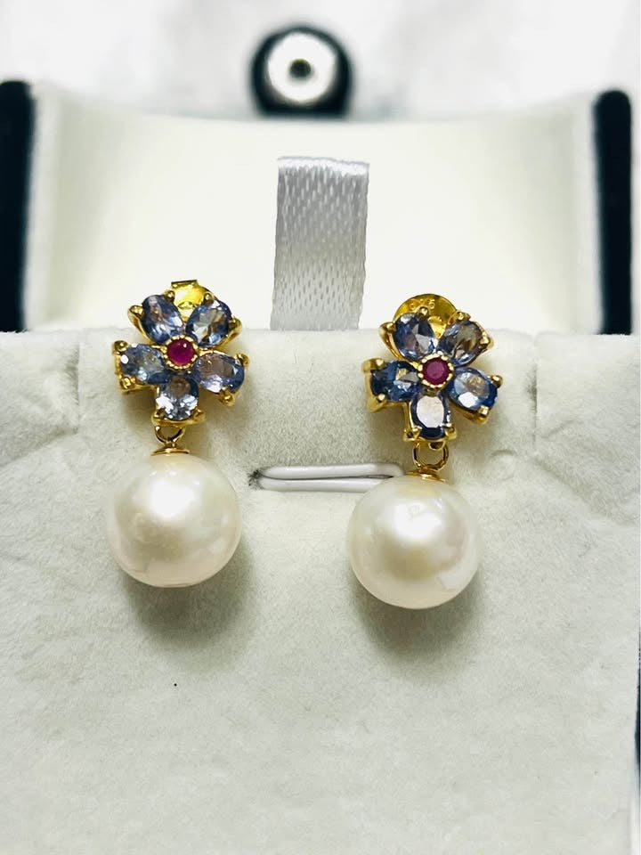 Beautiful natural tanzanite, ruby, and South Sea pearl earrings, perfect for any jewelry collection.