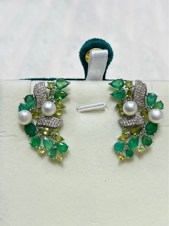 Elegant sterling silver earrings with a mix of Colombian emeralds, green sapphires, and lustrous pearls.
