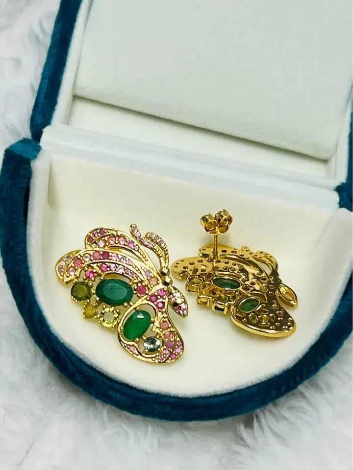 Back view of the gold butterfly earrings showcasing the setting and posts for the emeralds and sapphires.