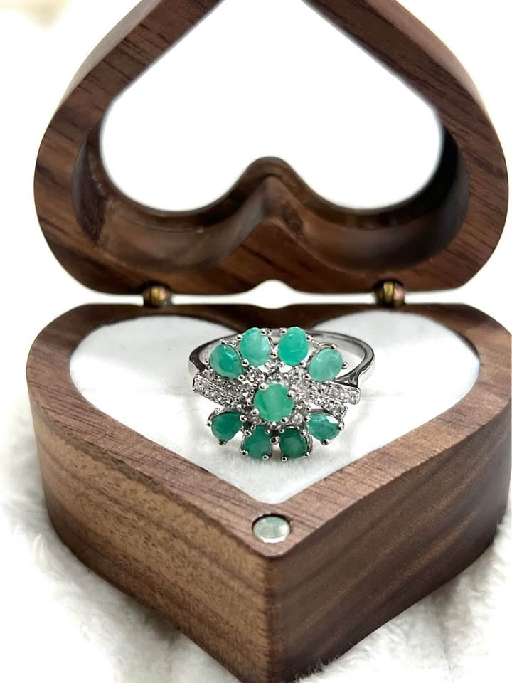 A vibrant Colombian emerald ring in 925 sterling silver, showcasing a beautiful cluster design of teardrop gems.