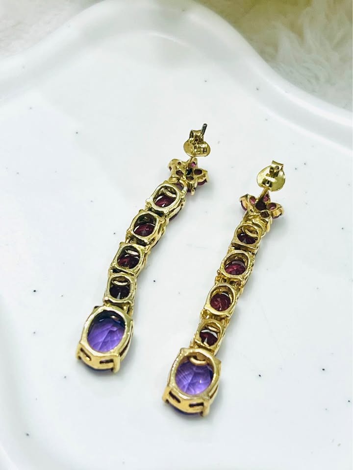 Back view of designer David Y earrings, showing the gold setting and post of the amethyst and ruby gems.