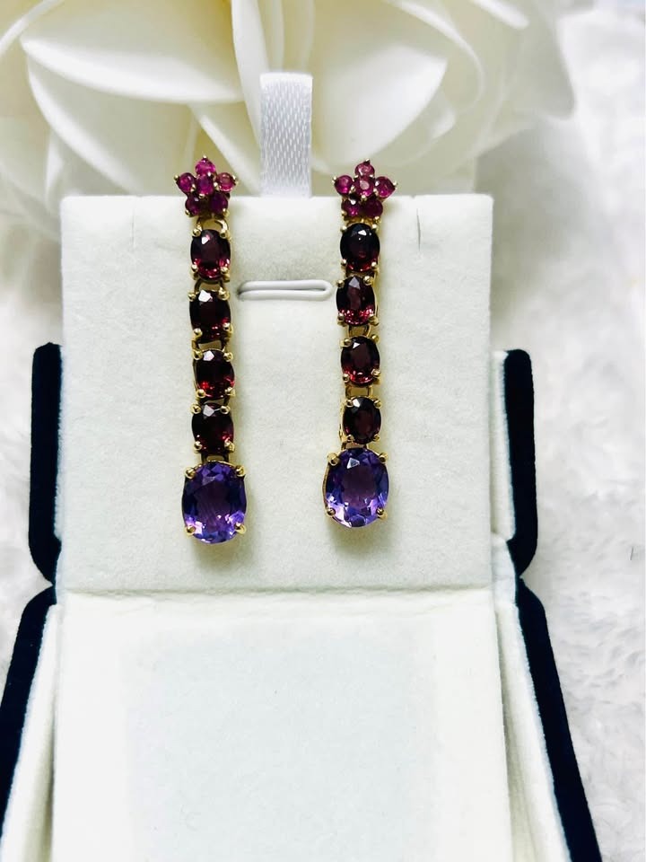 Designer David Y earrings featuring amethyst, rhodolite garnet, and ruby in a jewelry box for display.