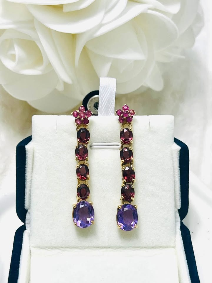 David Y genuine amethyst, rhodolite garnet, and ruby drop earrings in a white and black display box.