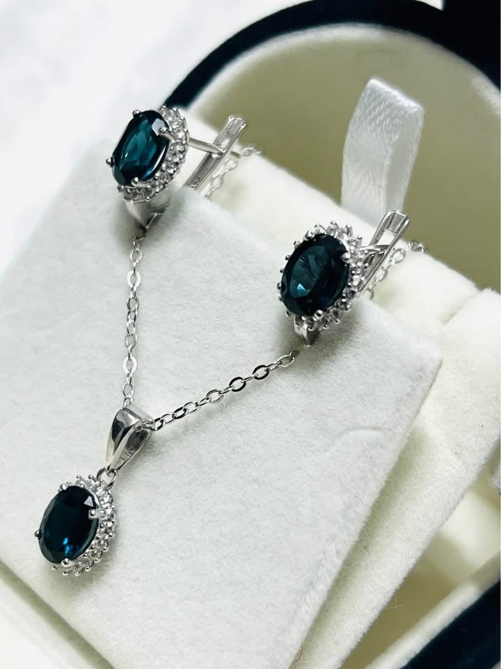 Deep blue natural London topaz jewelry set, featuring a coordinated necklace and earrings.