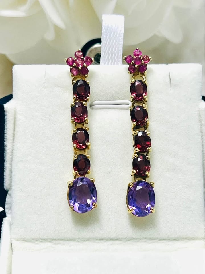 A pair of David Y designer drop earrings with large amethyst and rhodolite garnet gemstones.