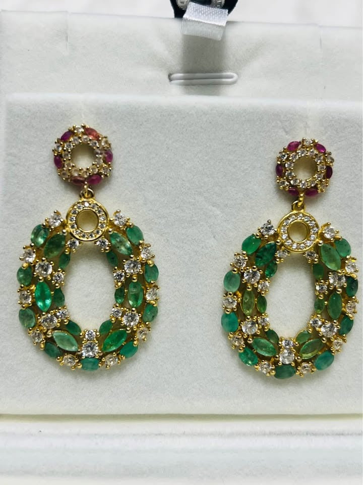 Elaborate vintage dangle earrings featuring natural emeralds, rubies, and cubic zirconias.