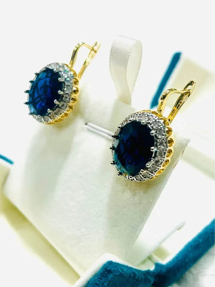 Elegant 18k gold vermeil earrings featuring large, faceted blue sapphires and CZ halos.