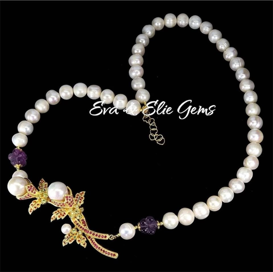 Elegant South Sea Pearl, ruby, and amethyst necklace. Handmade gold centerpiece with floral motifs and gemstone accents.