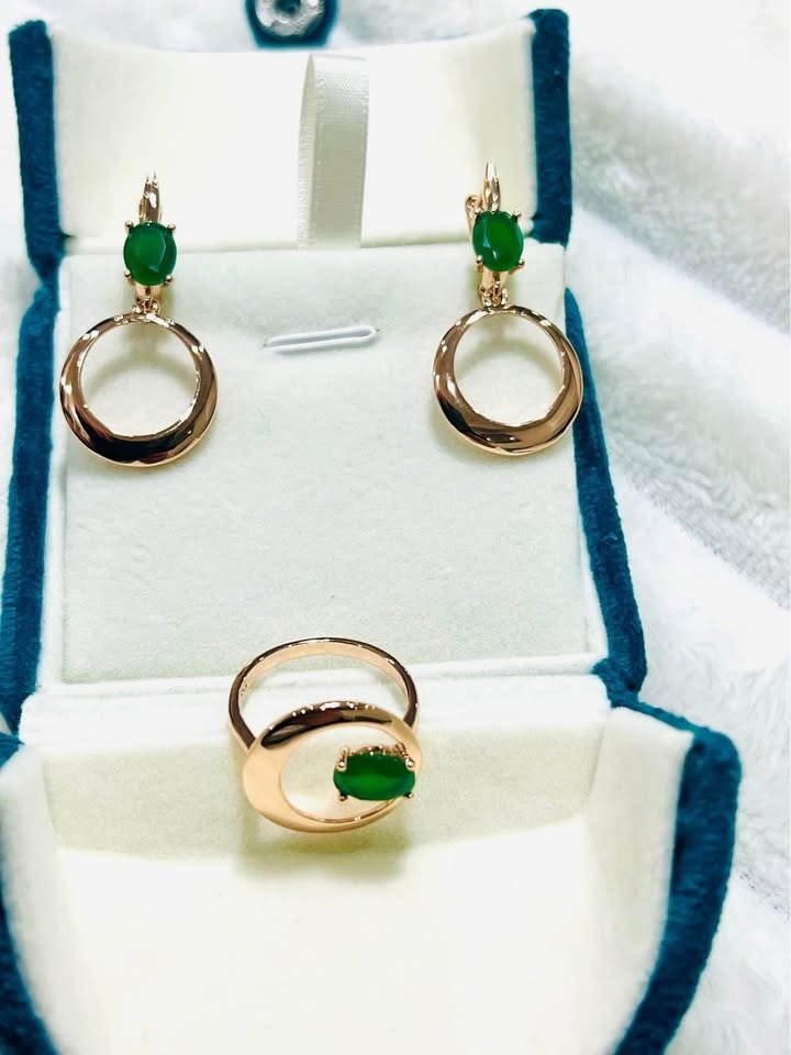 Matching set of 14k gold vermeil emerald earrings and ring, with a modern open circle design.