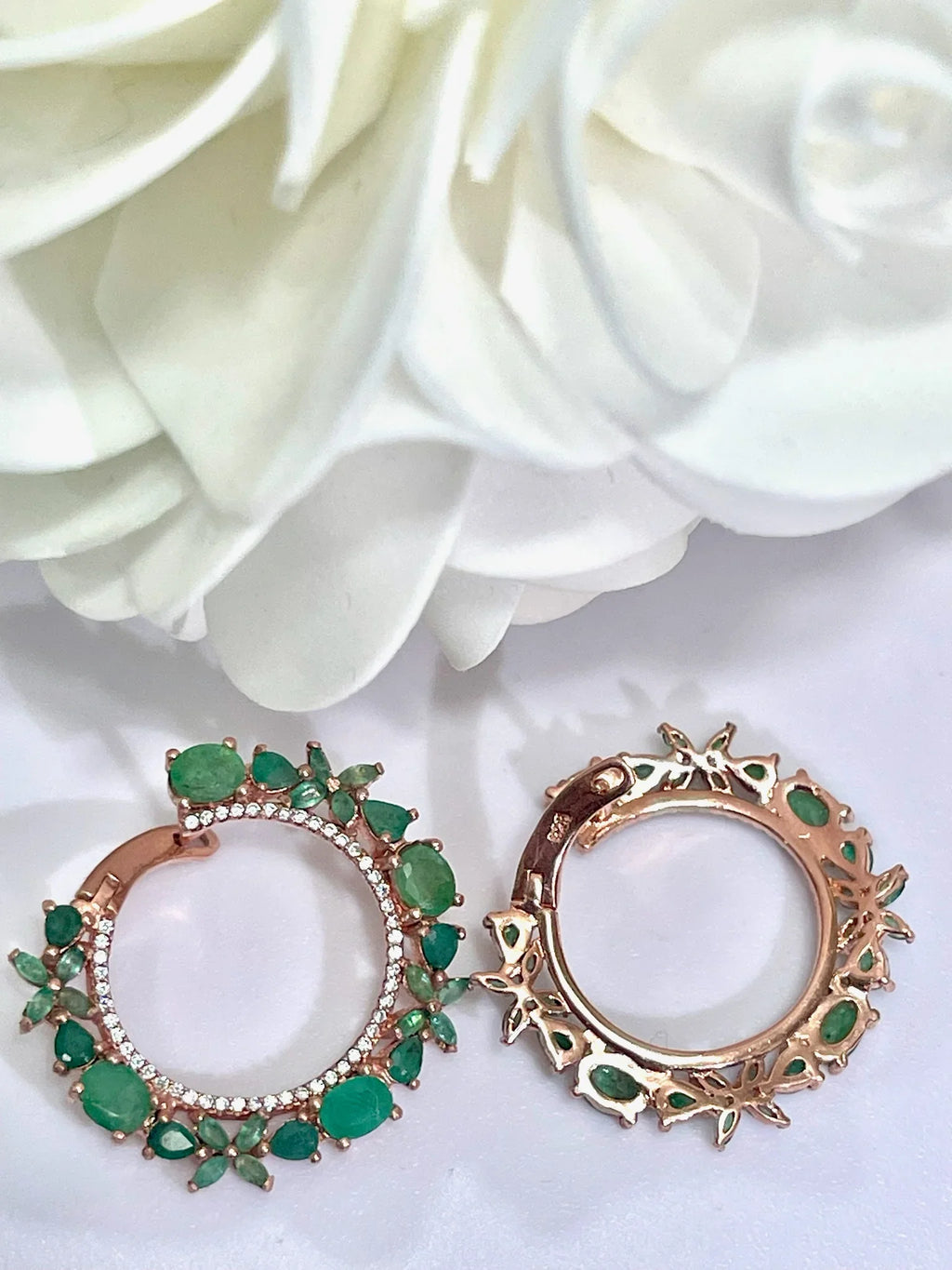 Front and back view of rose gold plated sterling silver hoop earrings, highlighting the emerald settings and craftsmanship
