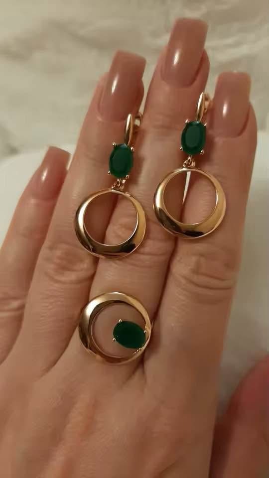 Matching 14k rose gold ring and dangle earrings with natural oval emerald gemstones.