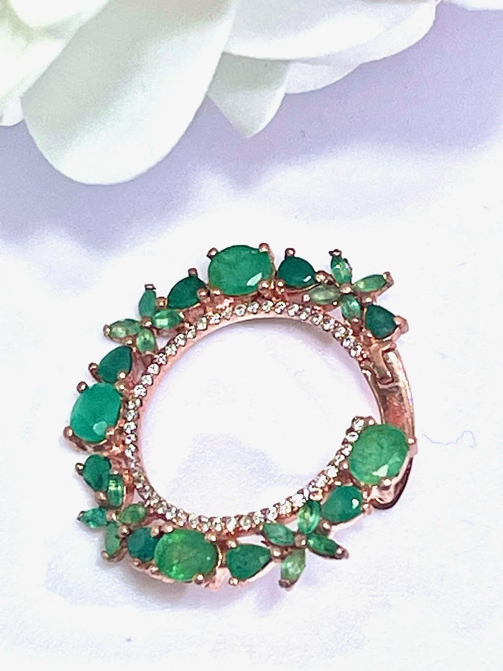 Single rose gold plated sterling silver hoop earring with vibrant green Colombian emeralds and a delicate diamond halo