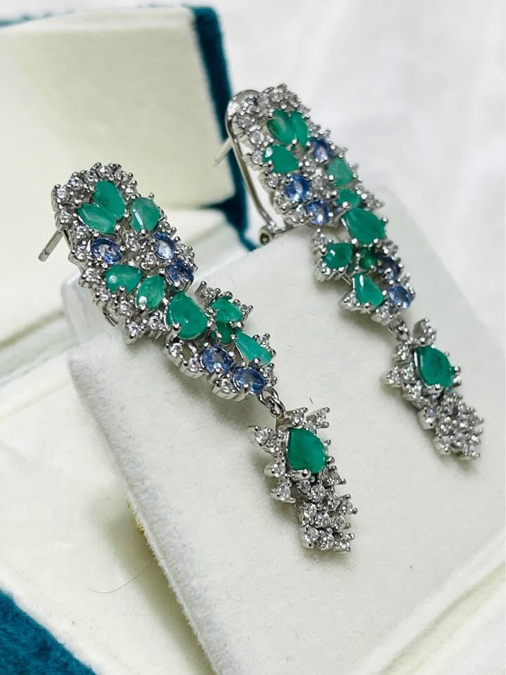 Fancy earrings with a mix of emerald and tanzanite, showing both the front of the design and the post backing.