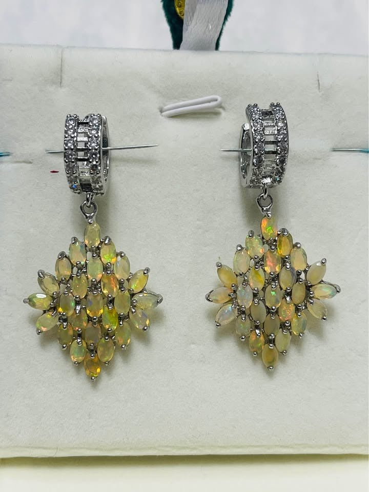 Stupendous Ethiopian fire opal dangle earrings with shimmering white topaz baguette huggie hoops.