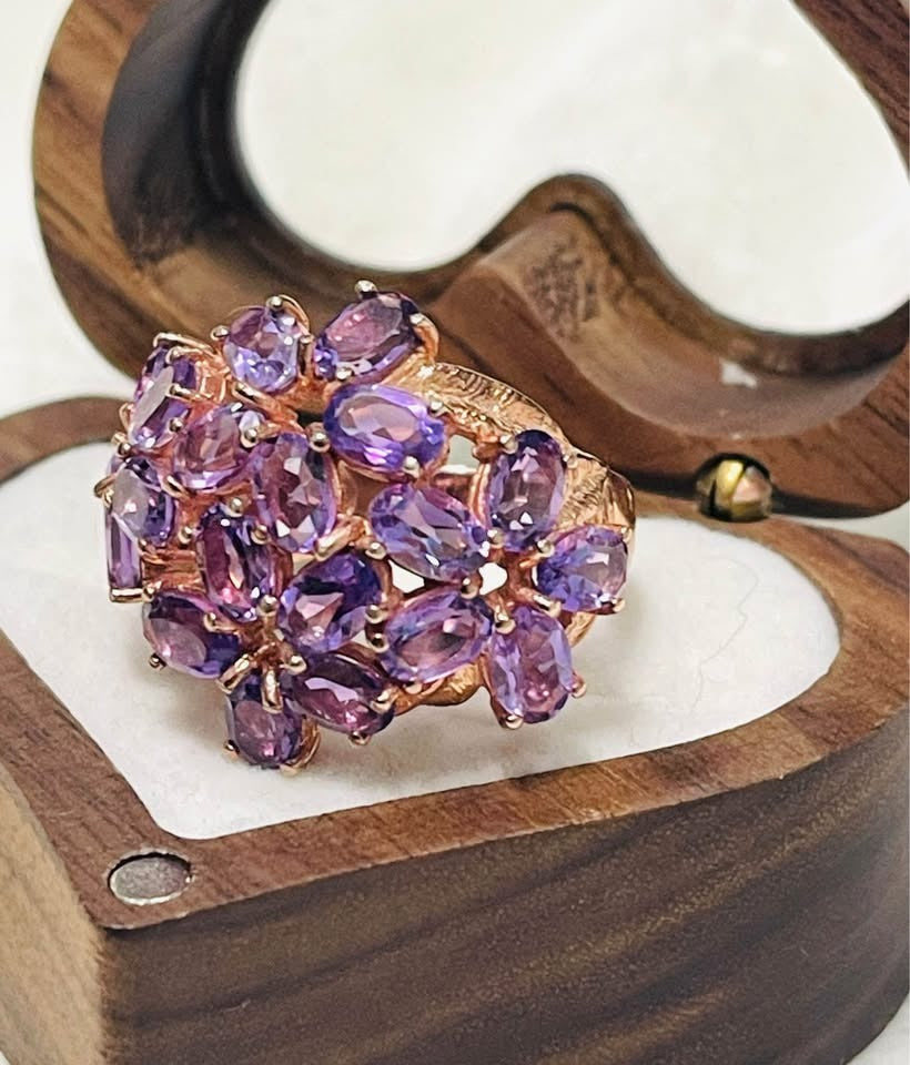 Exquisite amethyst flower cocktail ring in a rose gold setting, showcased in an open box.