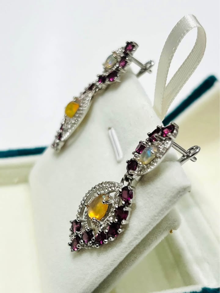  Side view of handcrafted fire opal and rhodolite garnet vintage-inspired dangle earrings.