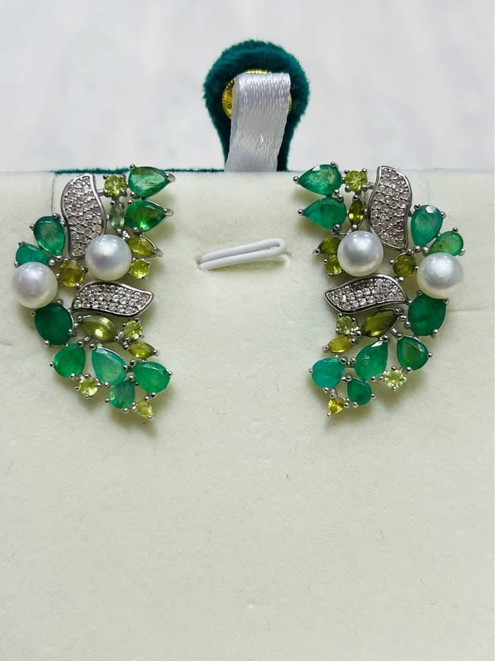 Floral cluster earrings with Colombian emeralds, green sapphires, and cultured pearls in a sterling silver setting.