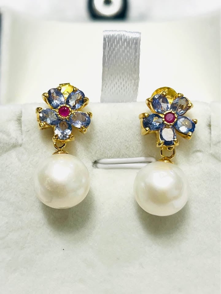 Genuine natural tanzanite, ruby, and South Sea pearl earrings featuring a floral design.