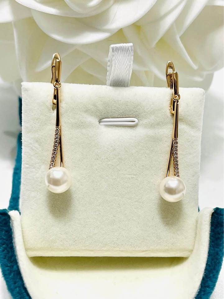 Front view of elegant gold-filled long dangle earrings featuring genuine freshwater pearls.