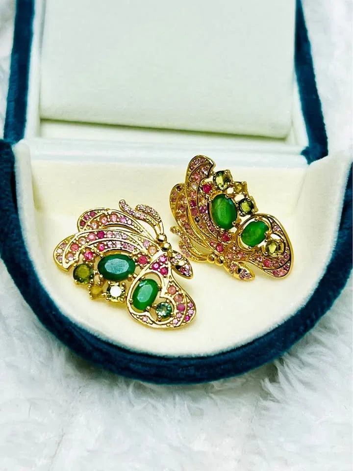 Handmade butterfly earrings with genuine Colombian emeralds and a mosaic of colorful sapphires.