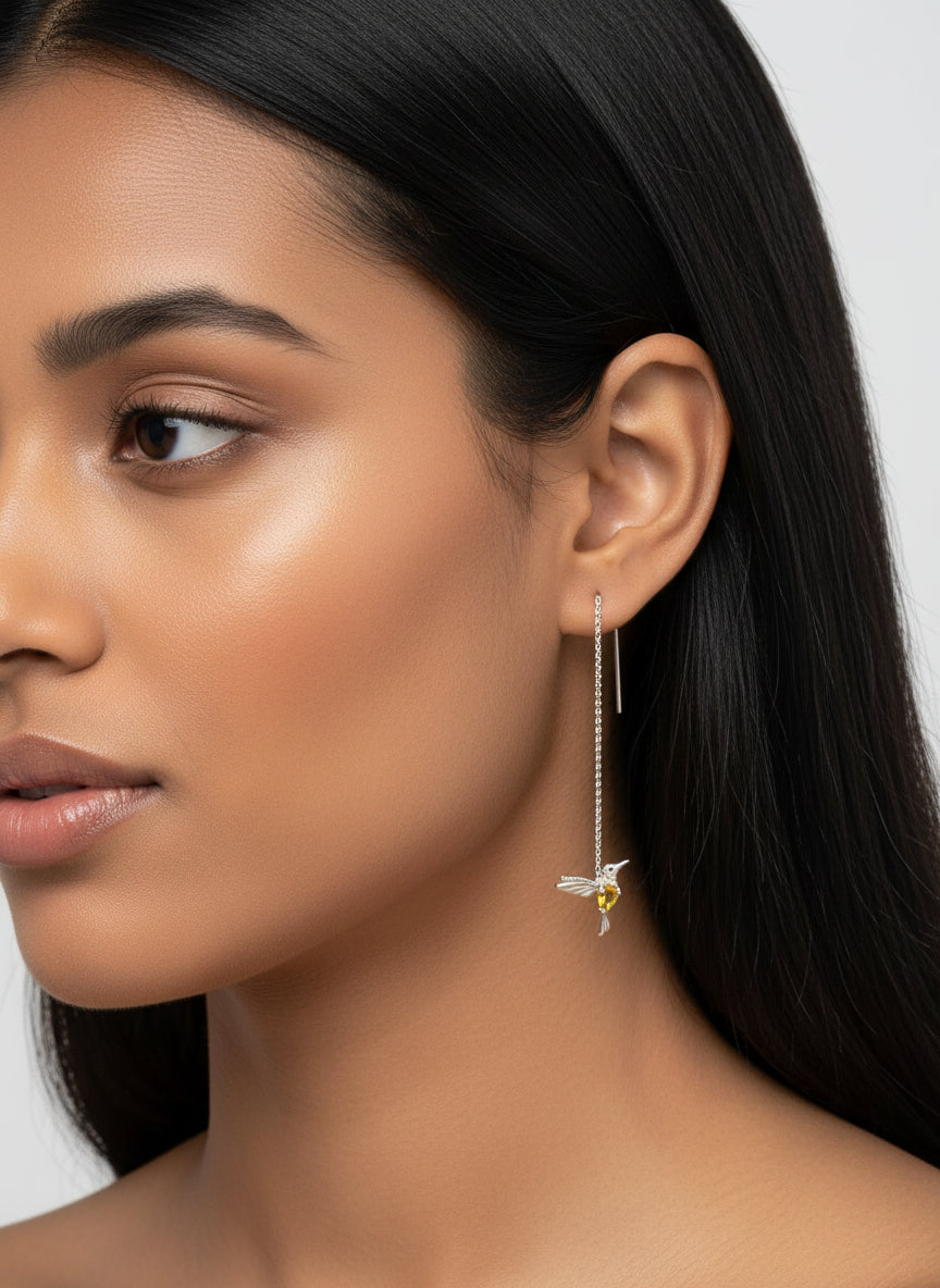  Single ear threader earring featuring a hummingbird with citrine and peridot, worn on a mannequin.