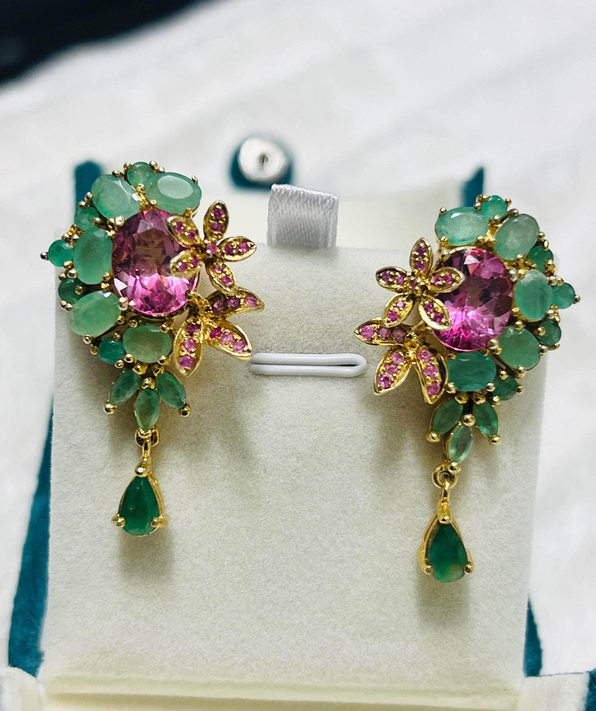 Pair of exquisite Italian-style earrings with emeralds, pink topaz, and sapphire accents in a floral design.