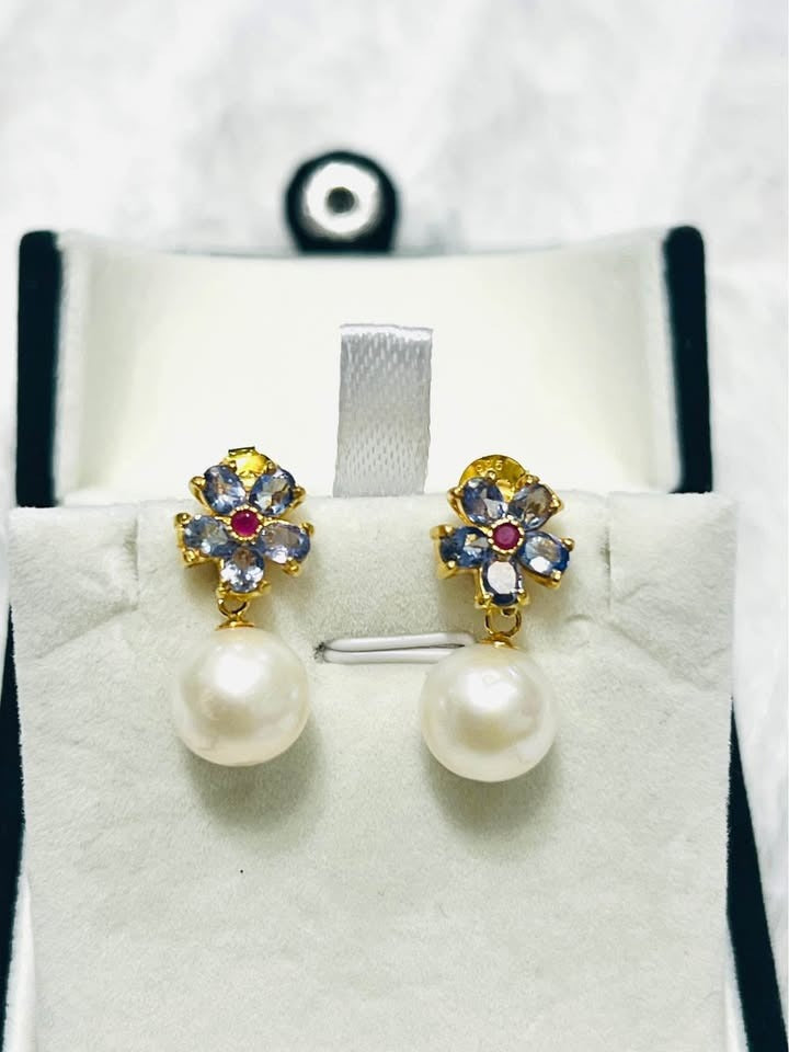  Luxurious natural tanzanite, ruby, and South Sea pearl drop earrings, perfect for special occasions.