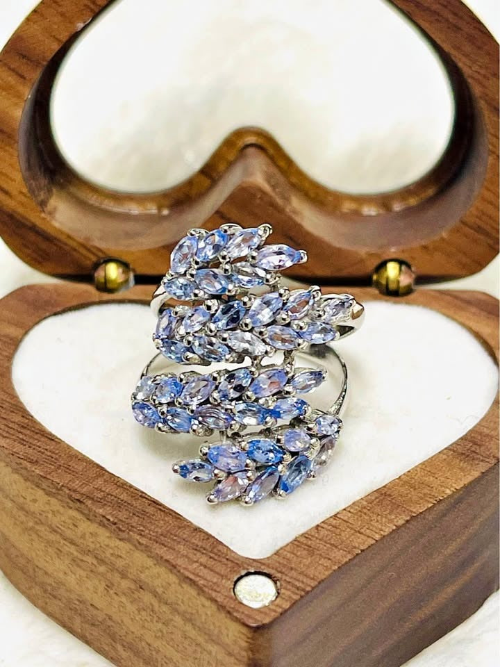  Marquise tanzanite cluster ring in sterling silver, displayed beautifully in an open heart-shaped box.