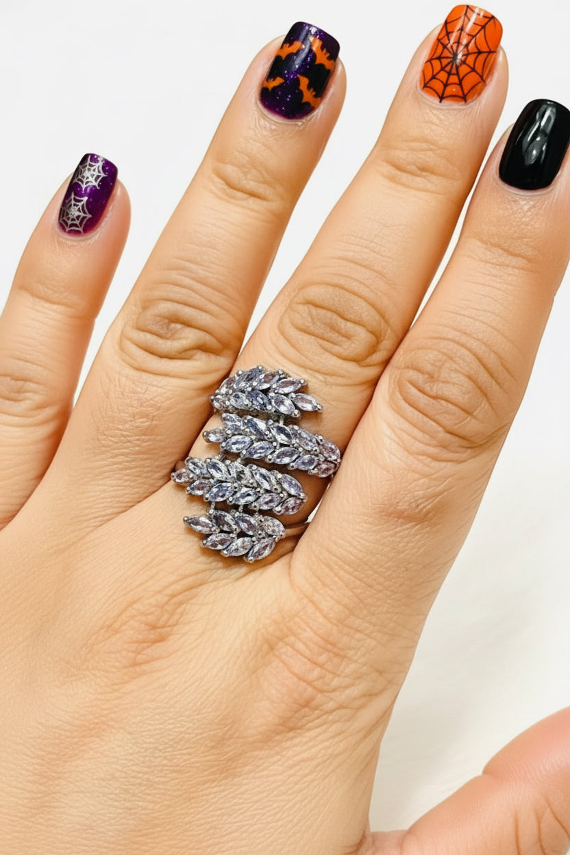  Sterling silver ring with a dazzling marquise-cut tanzanite cluster, worn on a hand.