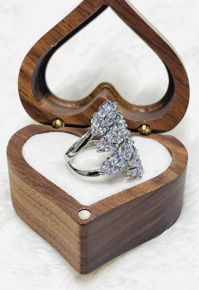 Profile of a sterling silver ring adorned with marquise tanzanite, presented in a heart box.