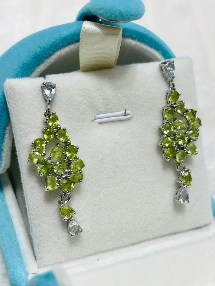 A pair of multi-gemstone dangle earrings with vibrant peridot and light aquamarine stones.