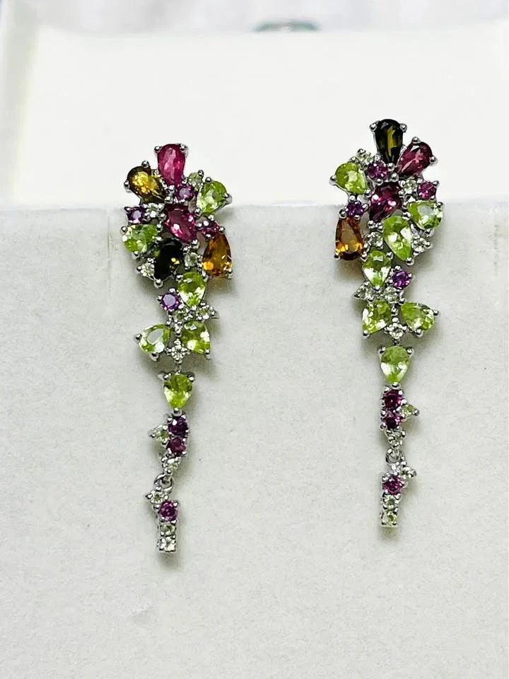 A pair of handmade multicolor gemstone dangle earrings with peridot, rhodolite garnet, citrine, and sapphire.