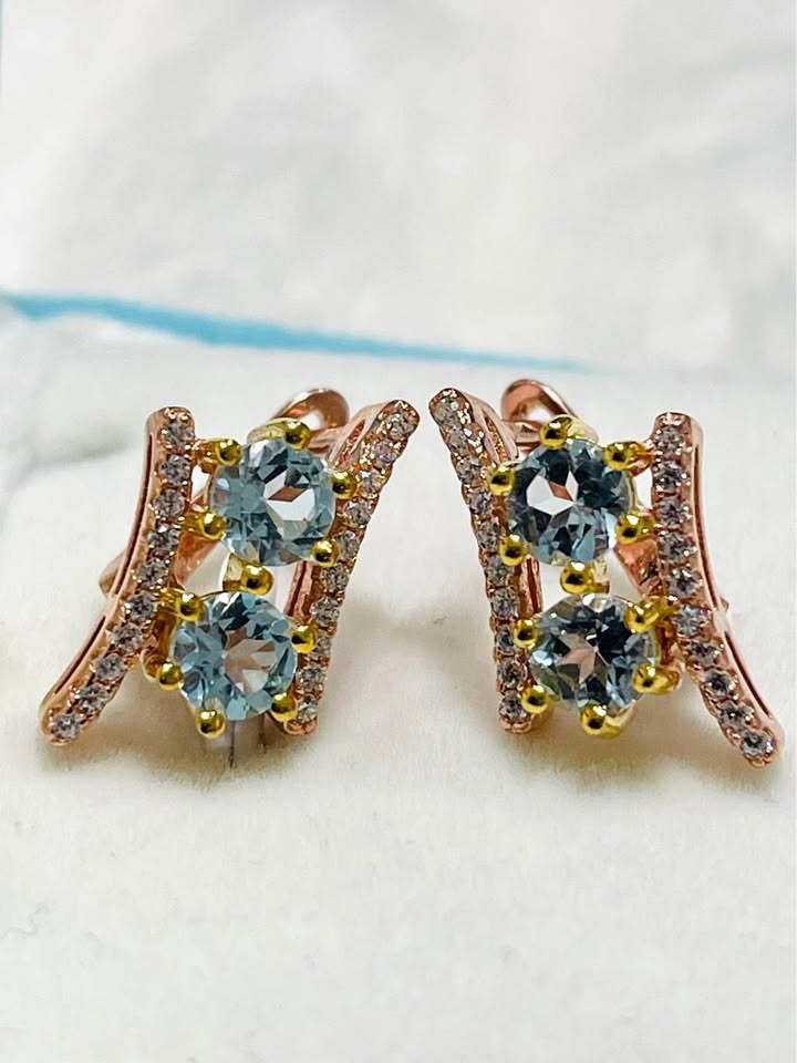 Pair of natural blue topaz and diamond-accent earrings set in rose gold, with a unique modern design