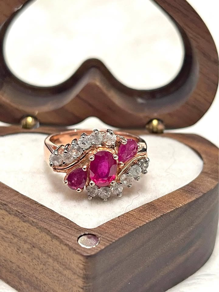 A beautiful ring with multiple natural Burmese rubies and white gemstones, set in rose gold plated sterling silver.
