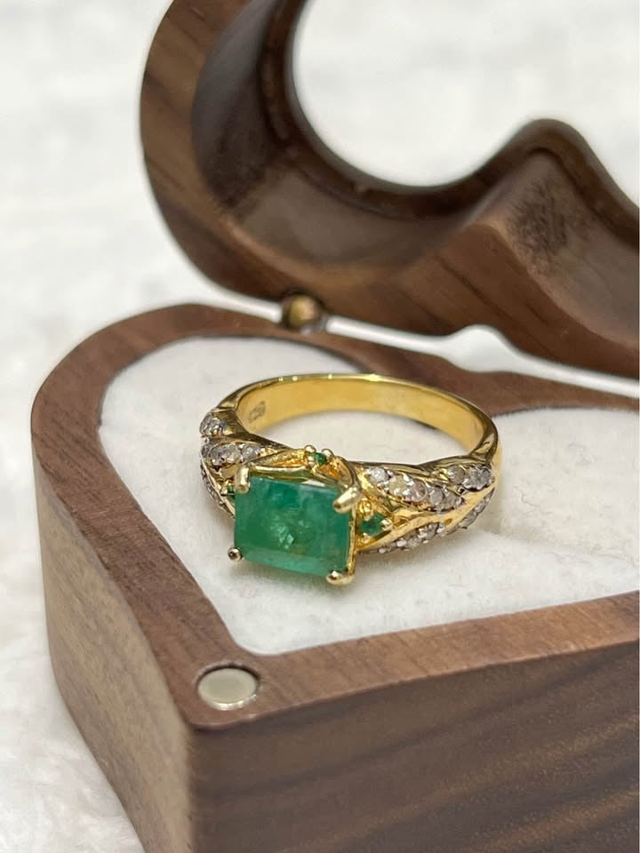  Natural Colombian emerald and diamond ring in yellow gold, intricate band design in a heart box.