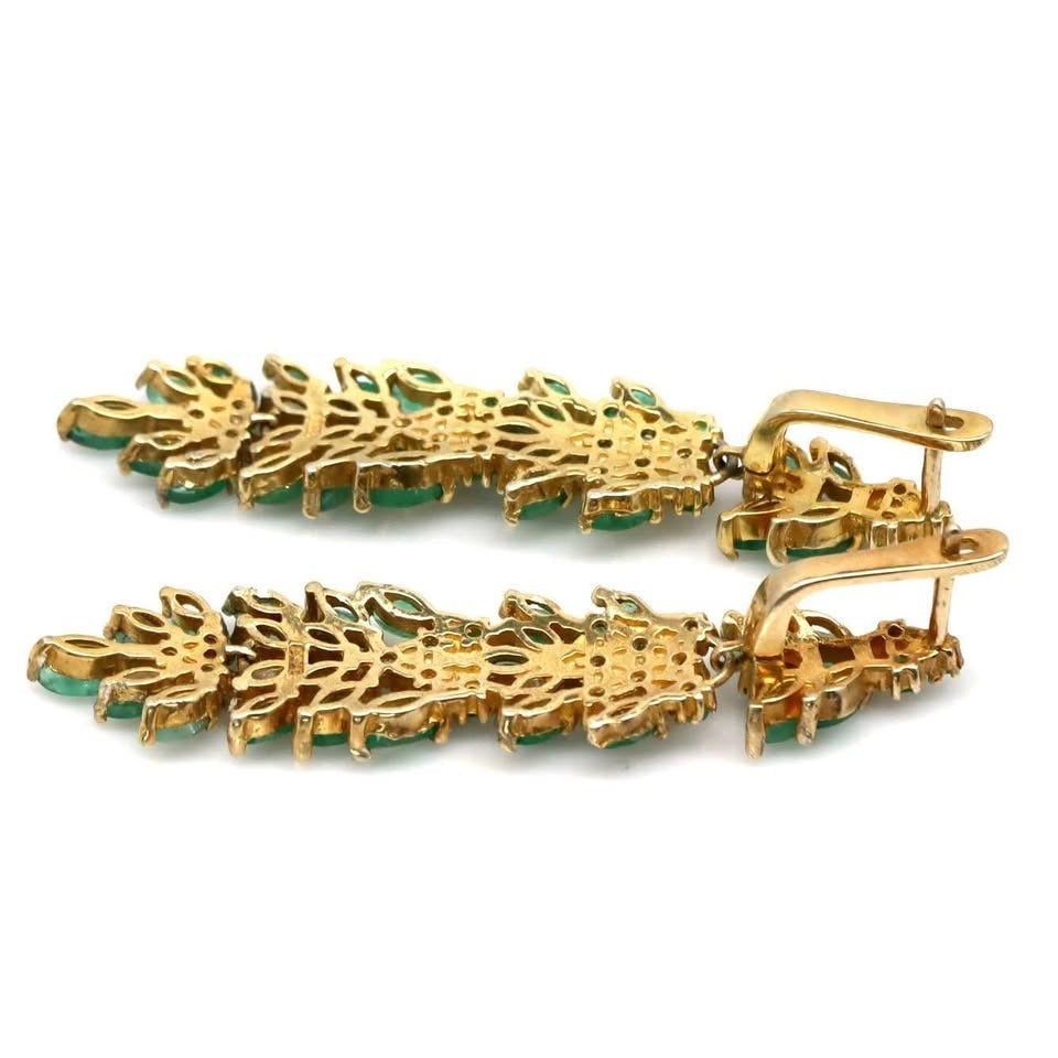  Detailed back view of fancy Colombian emerald earrings, highlighting the gold setting and closure.