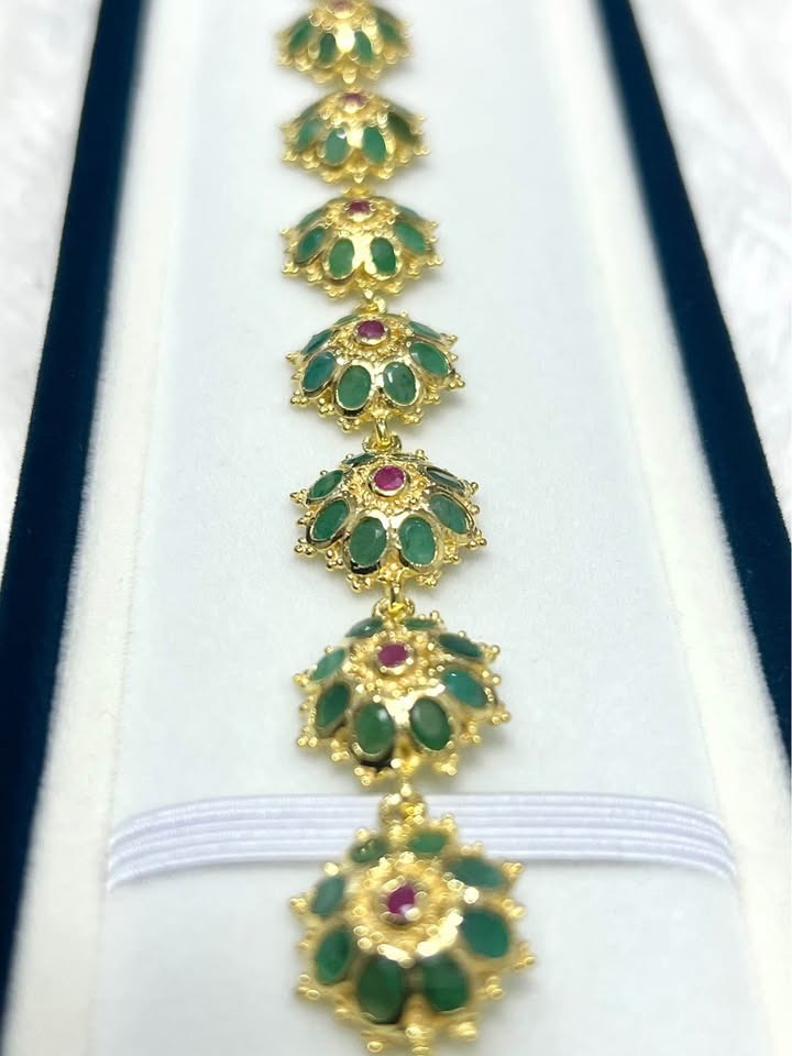 Detailed top-down shot of the bracelet's center links, showcasing the floral design.