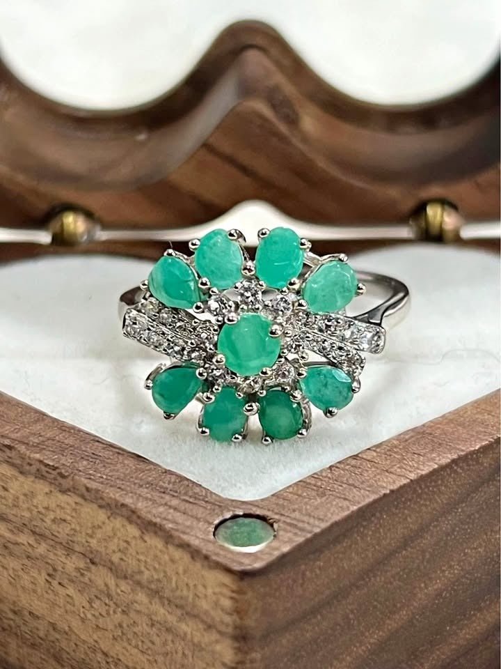 This striking flower-shaped ring features genuine Colombian emeralds set in high-quality sterling silver.
