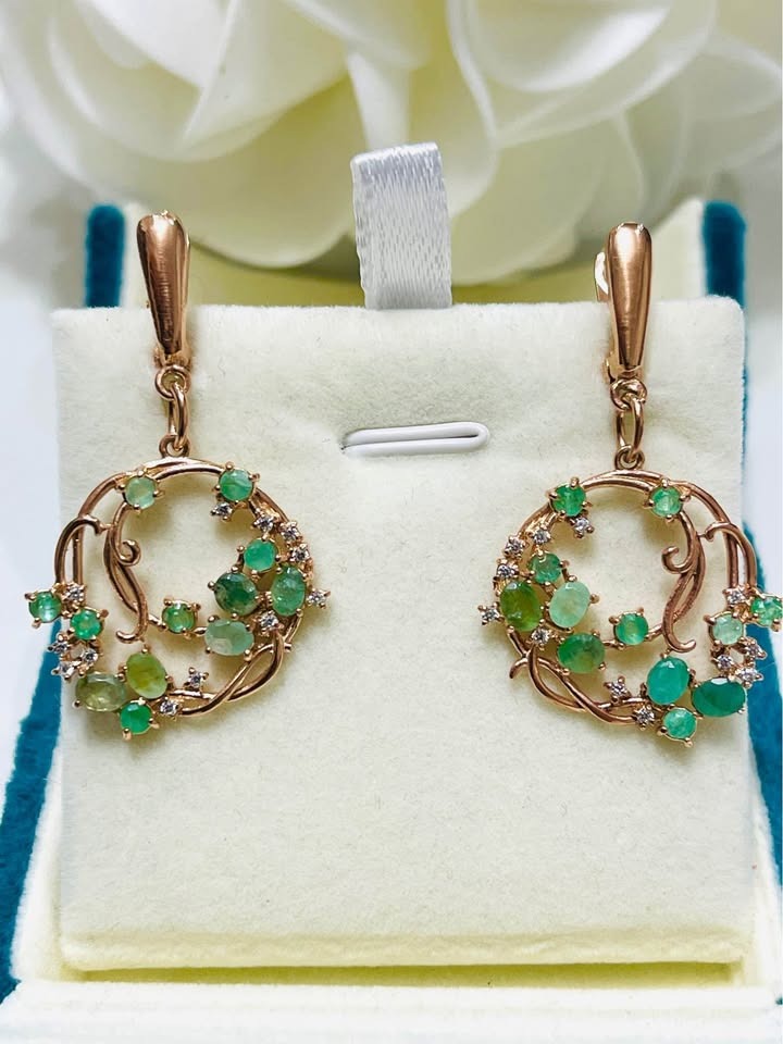 Front view of natural emerald hula hoop earrings in polished sterling silver.