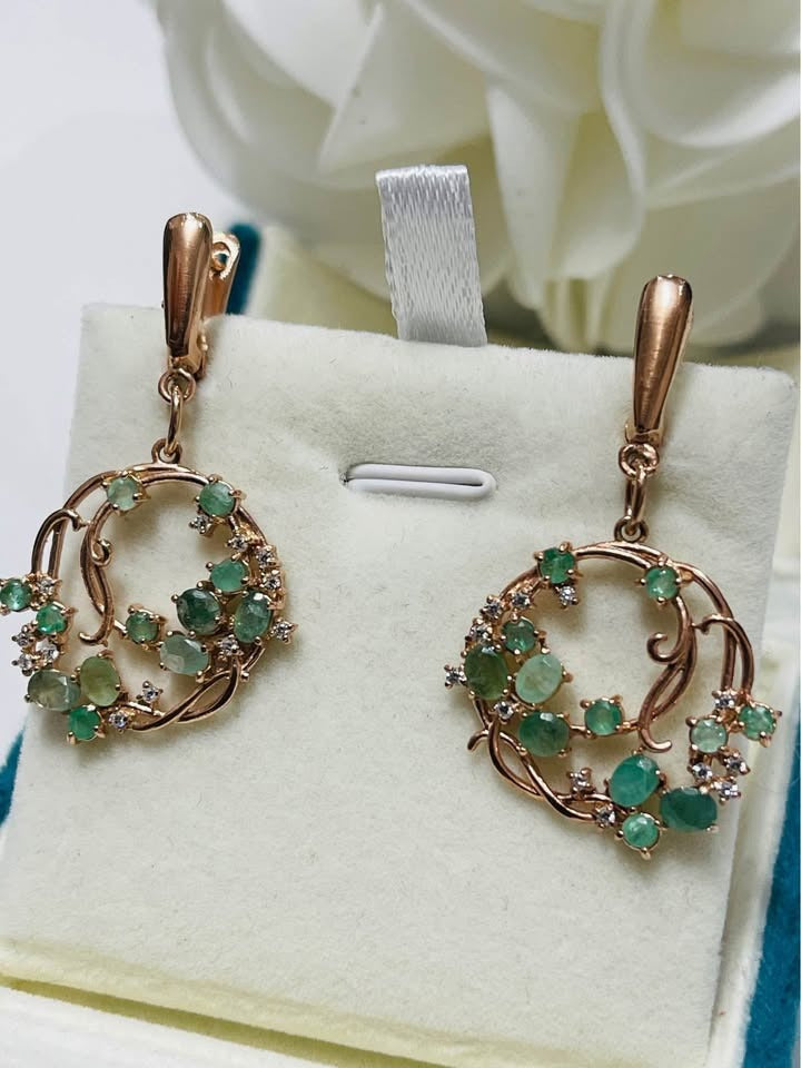 Pair of natural emerald sterling silver hula hoop earrings displayed on a white background.