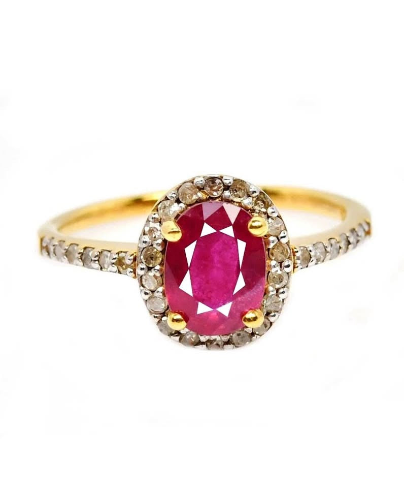 Front view of a vibrant natural ruby and natural diamond halo ring on white background.
